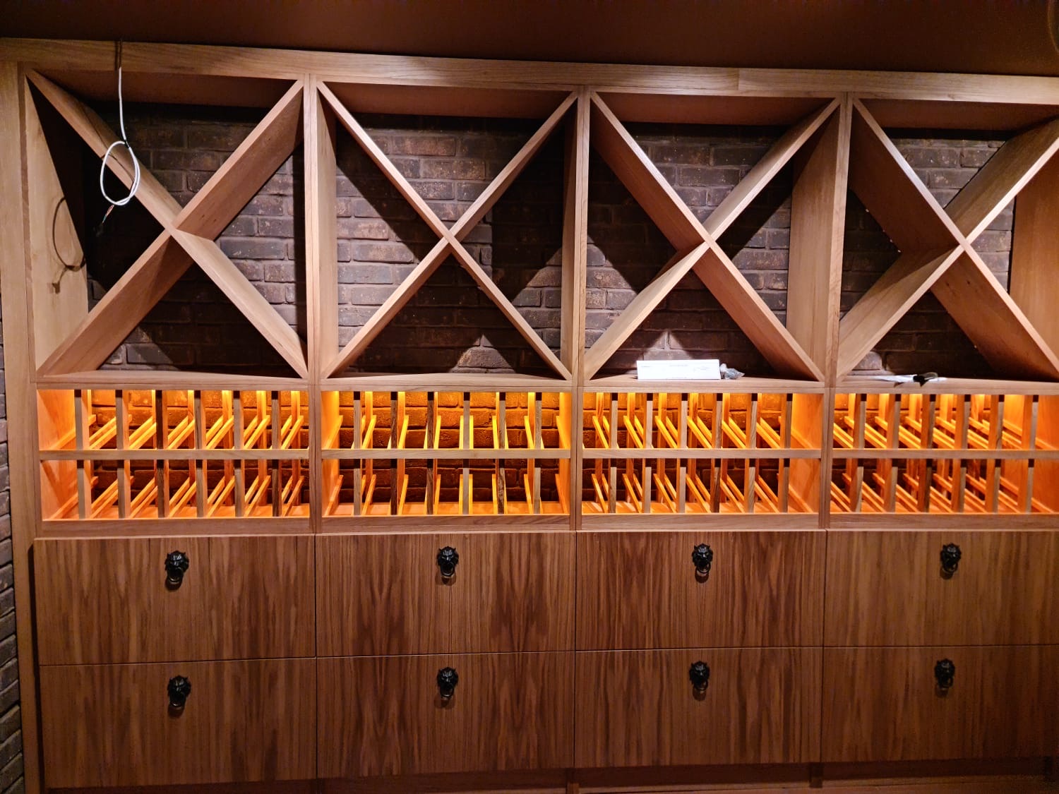 Four-bay X-racking with drawer base and forged pulls.