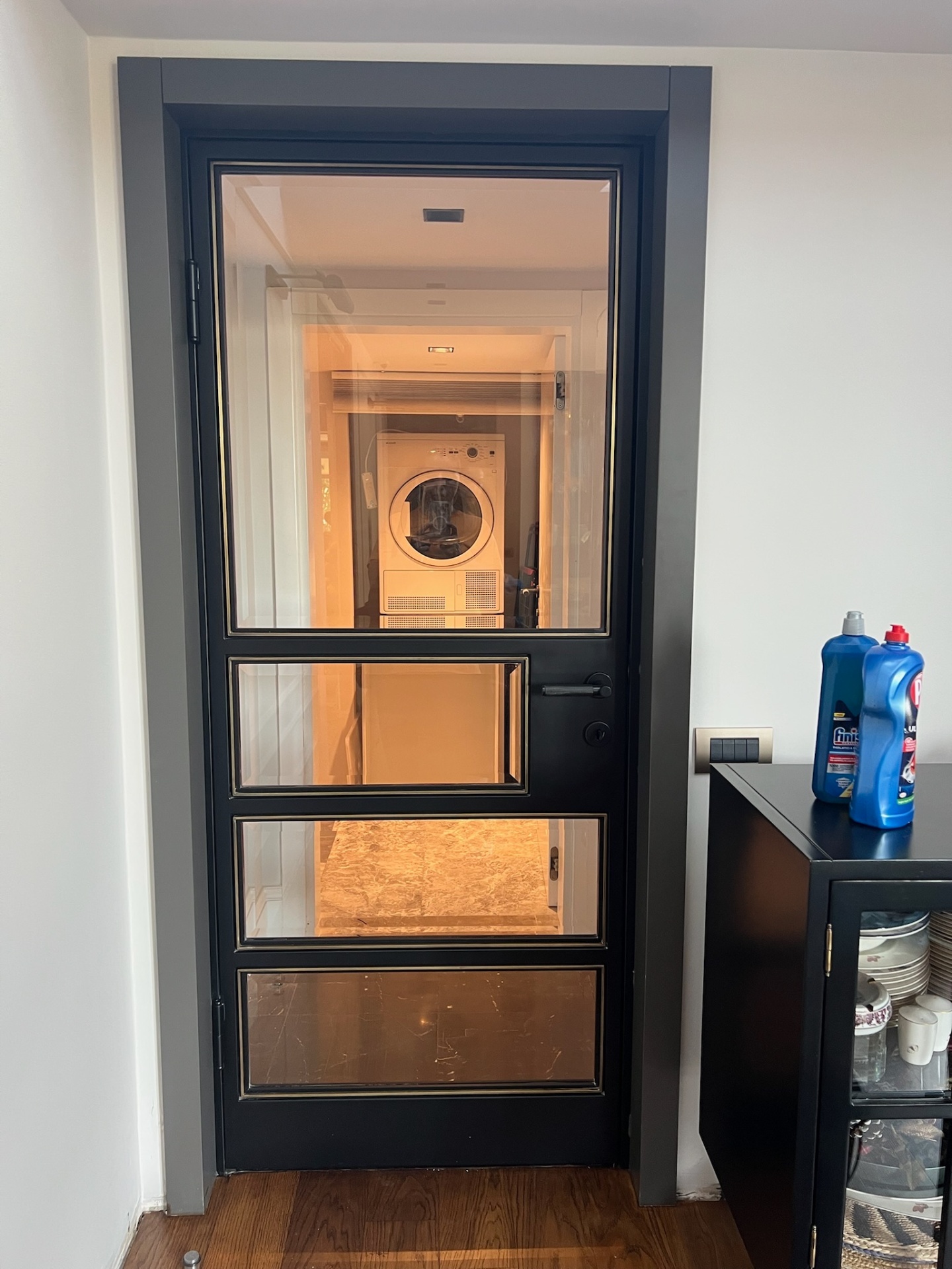 Steel-framed Crittall-style utility door with bronze inlay