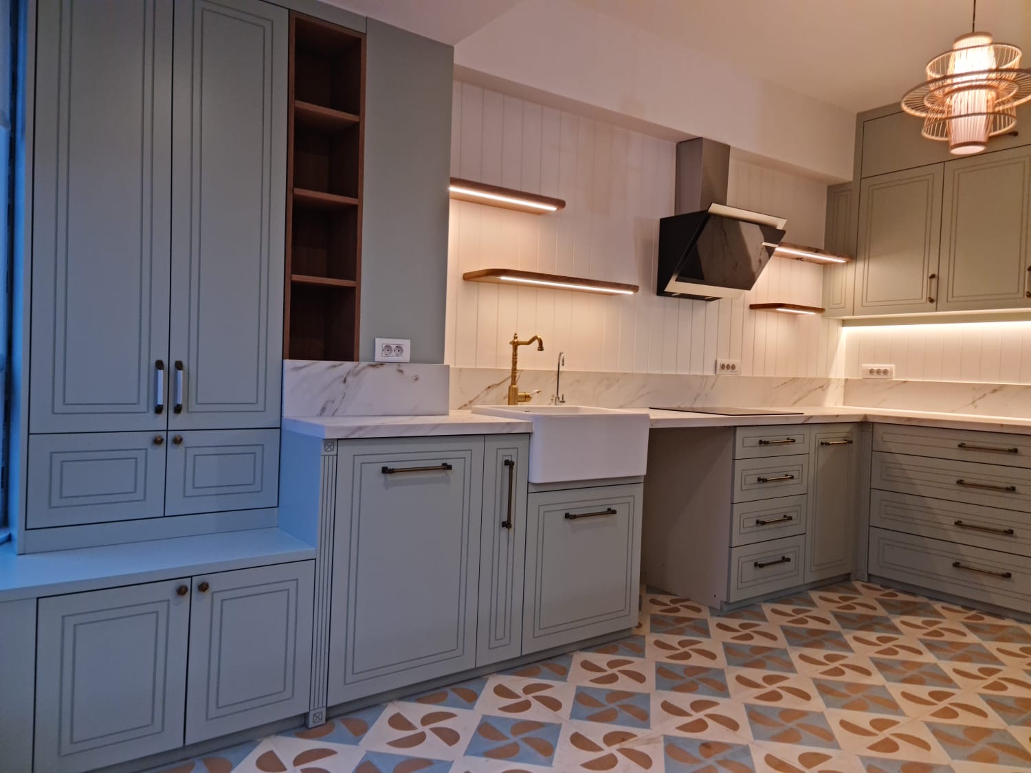Dove grey in-frame kitchen with brass tapware and encaustic tile floor