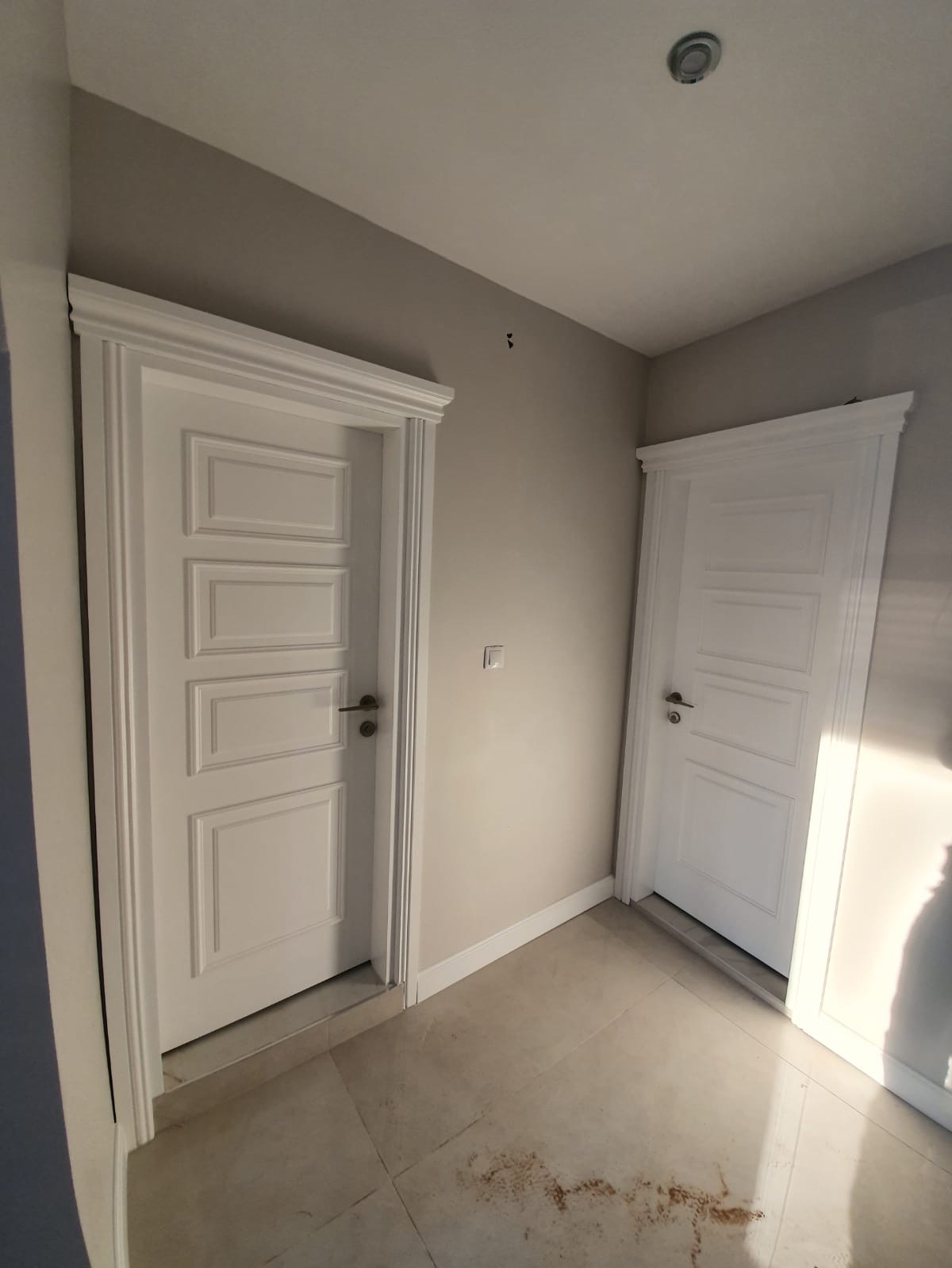 Ivory panelled doors with sculpted architraves — residential suite