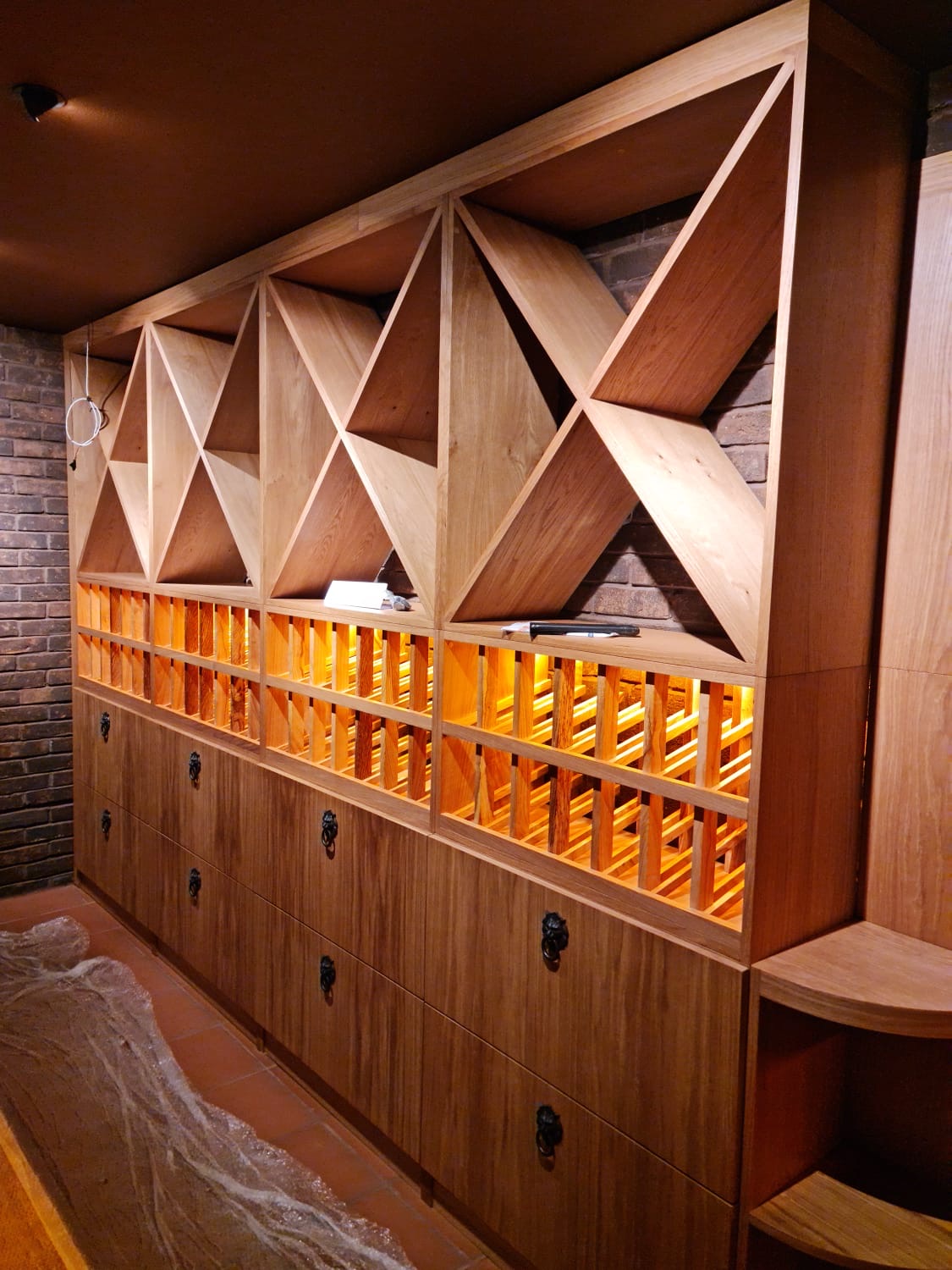 Diamond bin display over lattice racks with iron lion pulls.