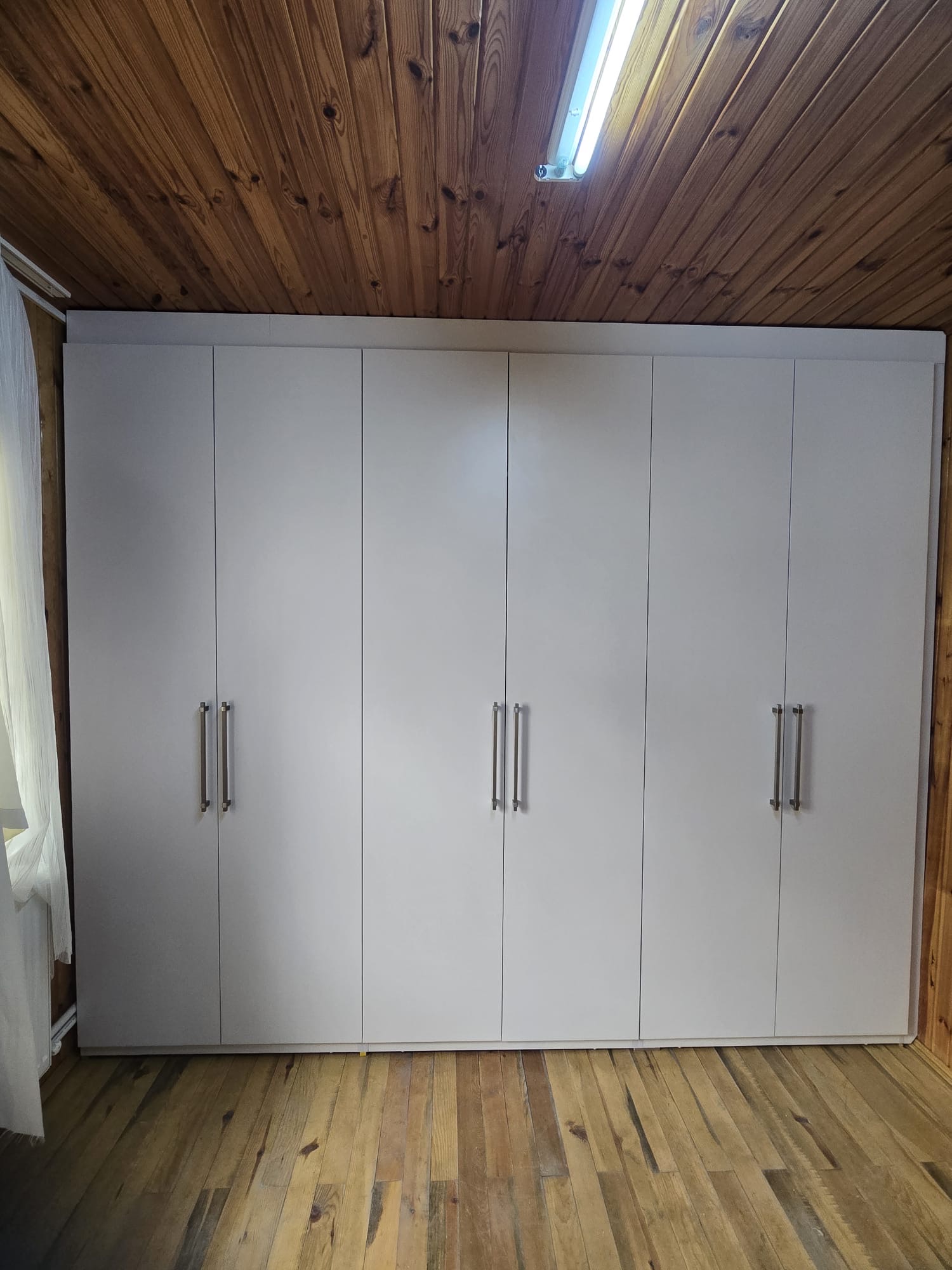 Six-door bespoke wardrobe with brass hardware
