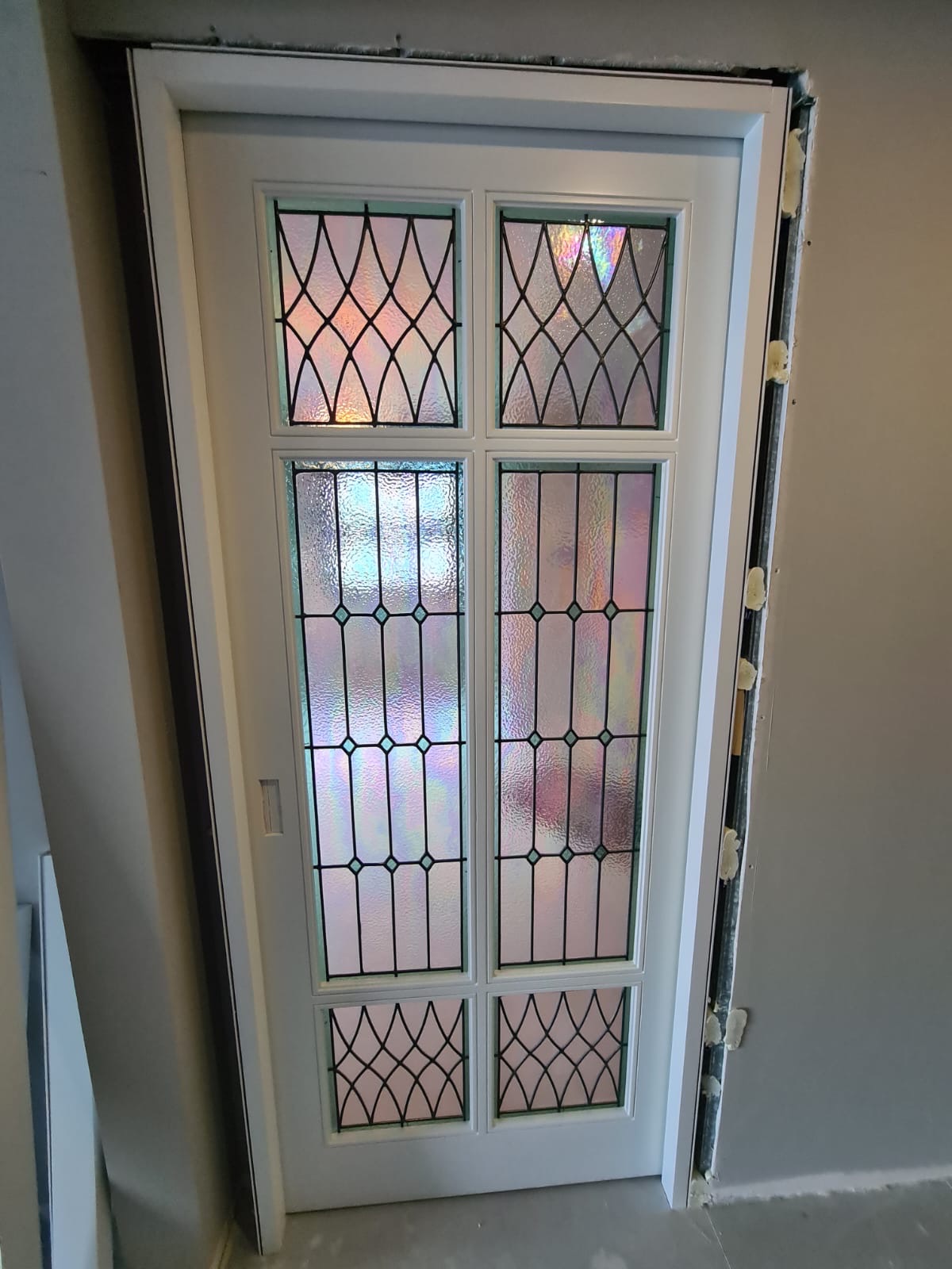 Iridescent leaded glass door with lattice and diamond panels