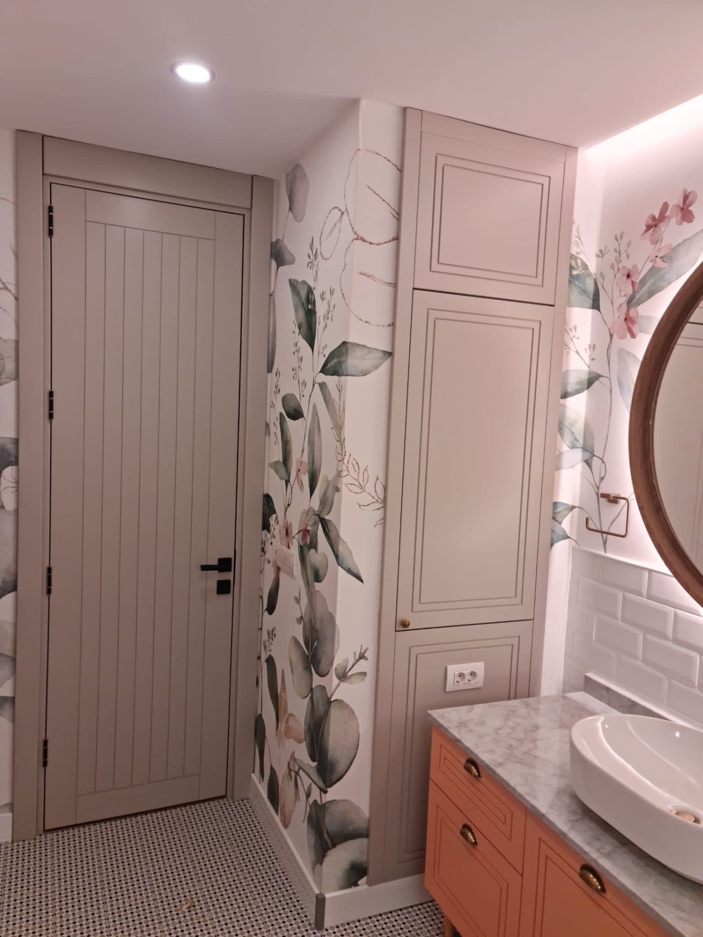 Stone-painted in-frame joinery paired with botanical mural and terracotta vanity.