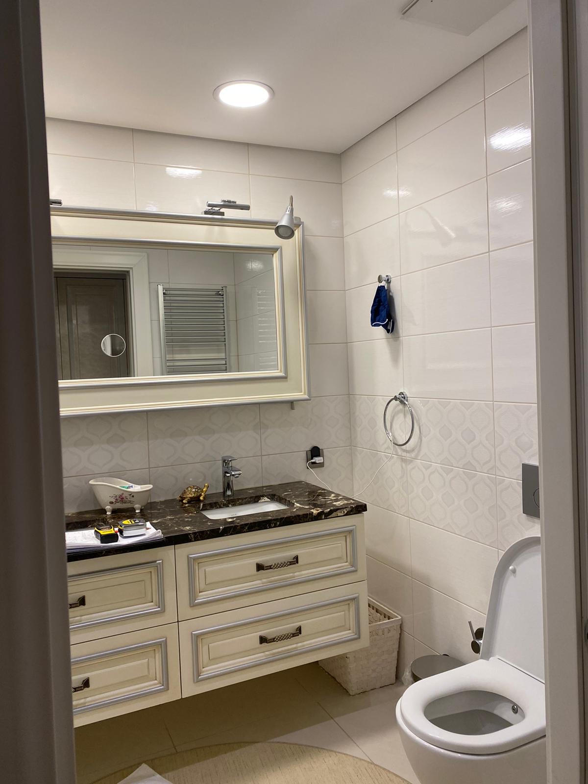 Classical ivory vanity with silver leaf detailing and Emperador marble top