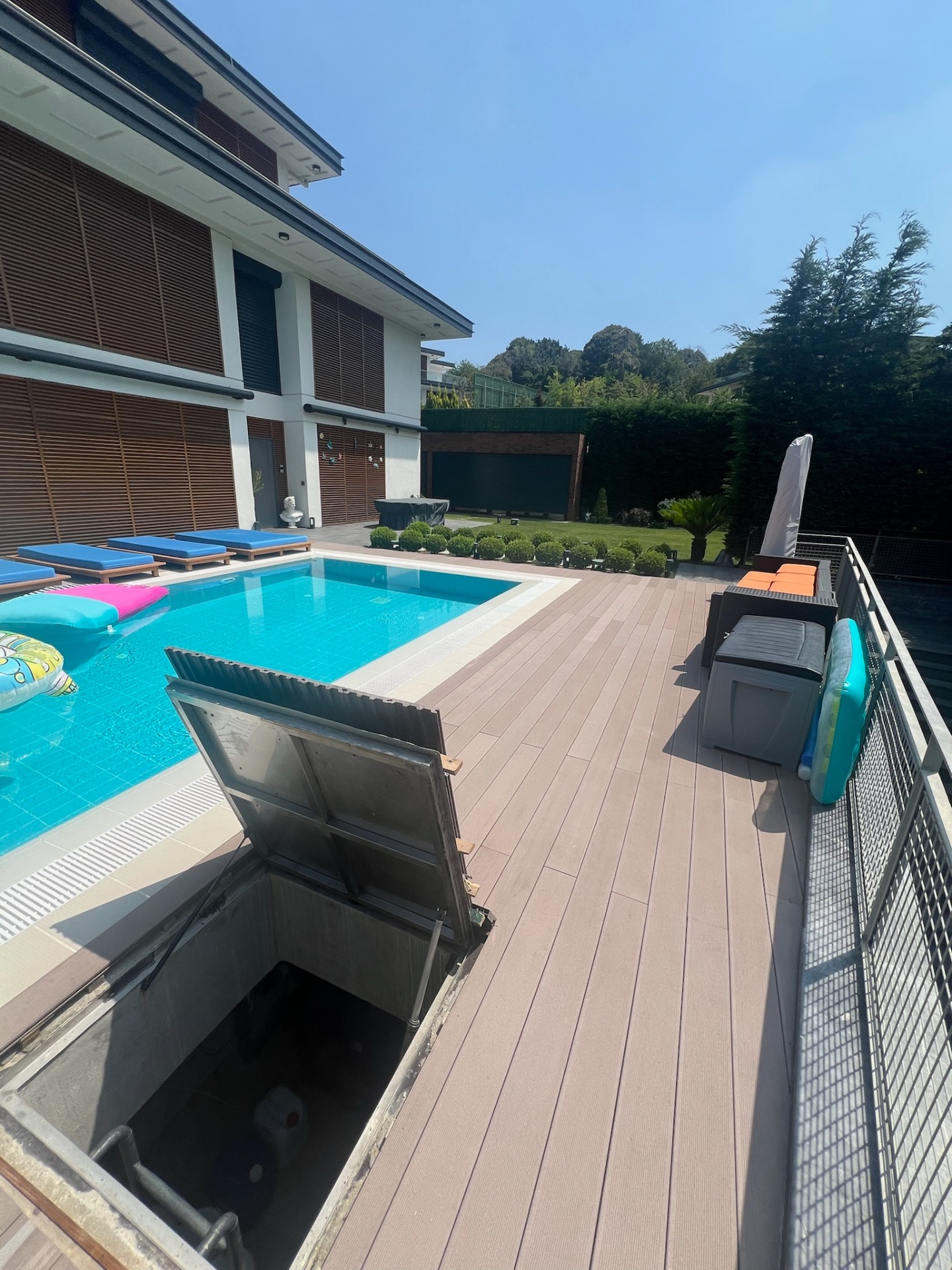 Open service hatch — engineered access built into the composite decking.