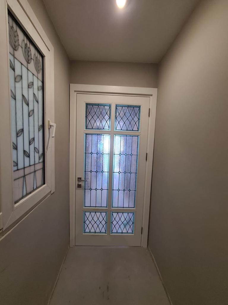 Leaded stained-glass entrance door with diamond and tulip motifs