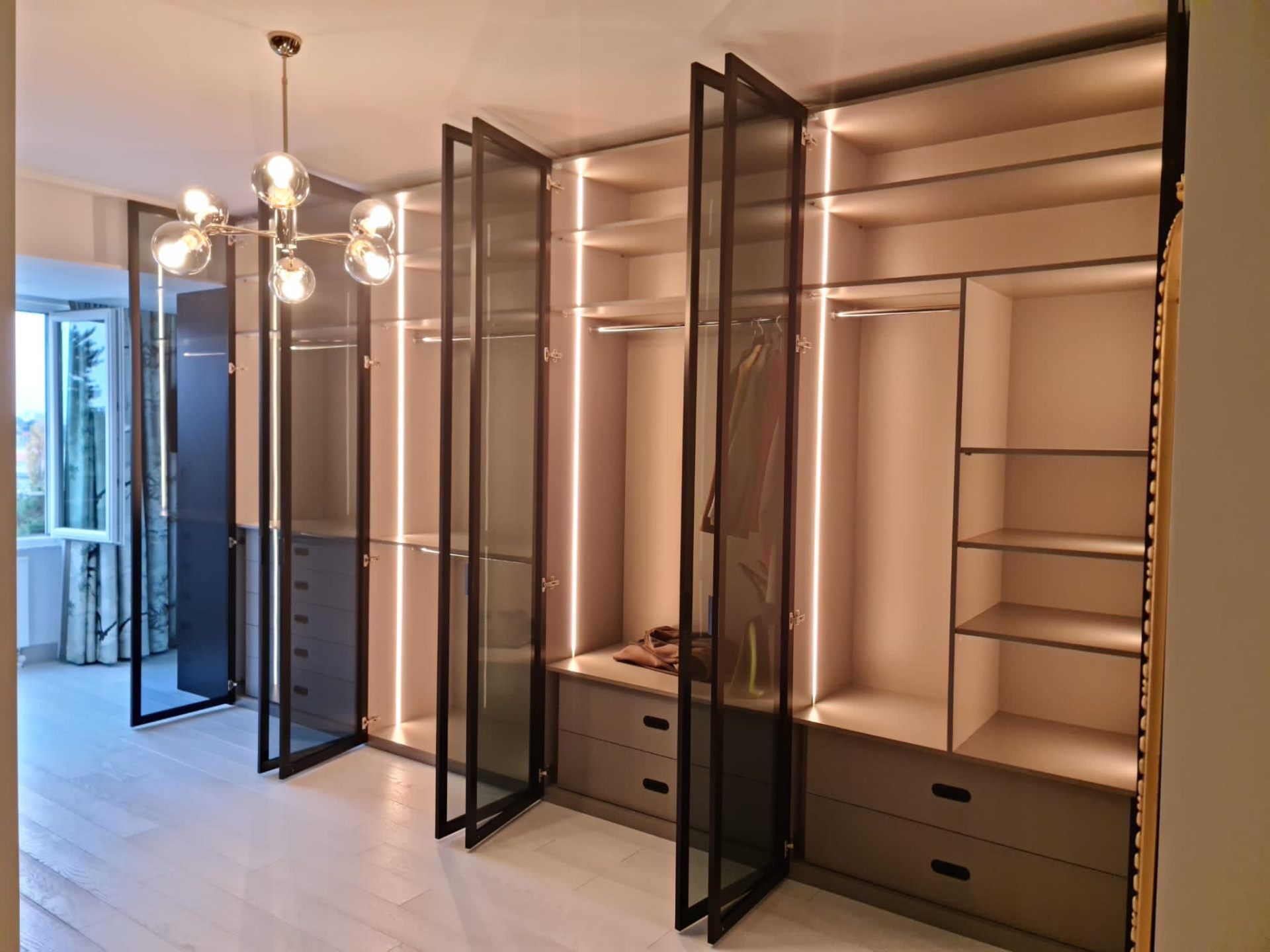 Framed glass wardrobe system with integrated LED lighting