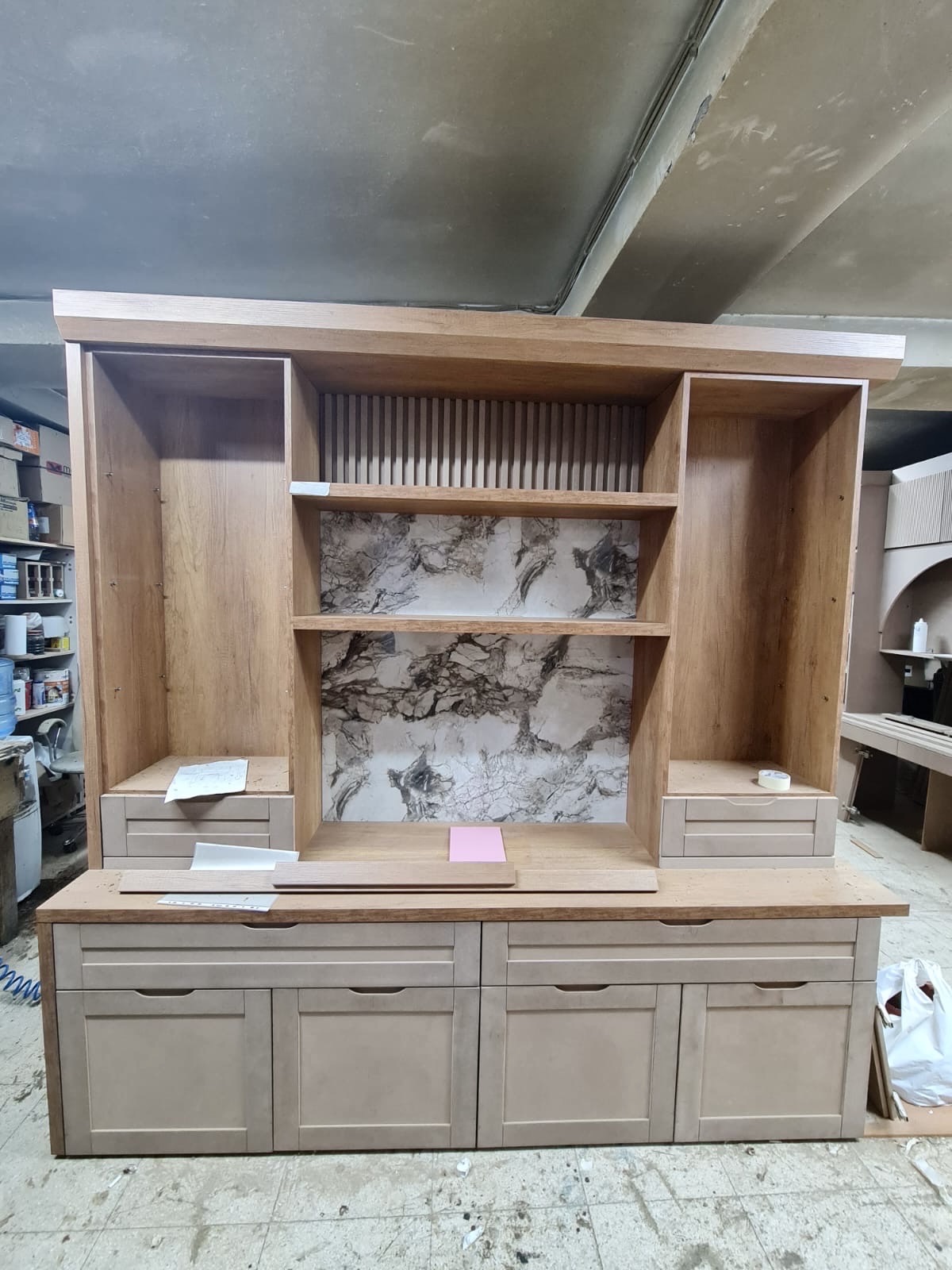 Oak media hutch with marble backing and fluted centre panel — workshop stage