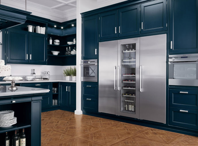 Deep navy shaker kitchen with integrated wine tower and stainless appliances