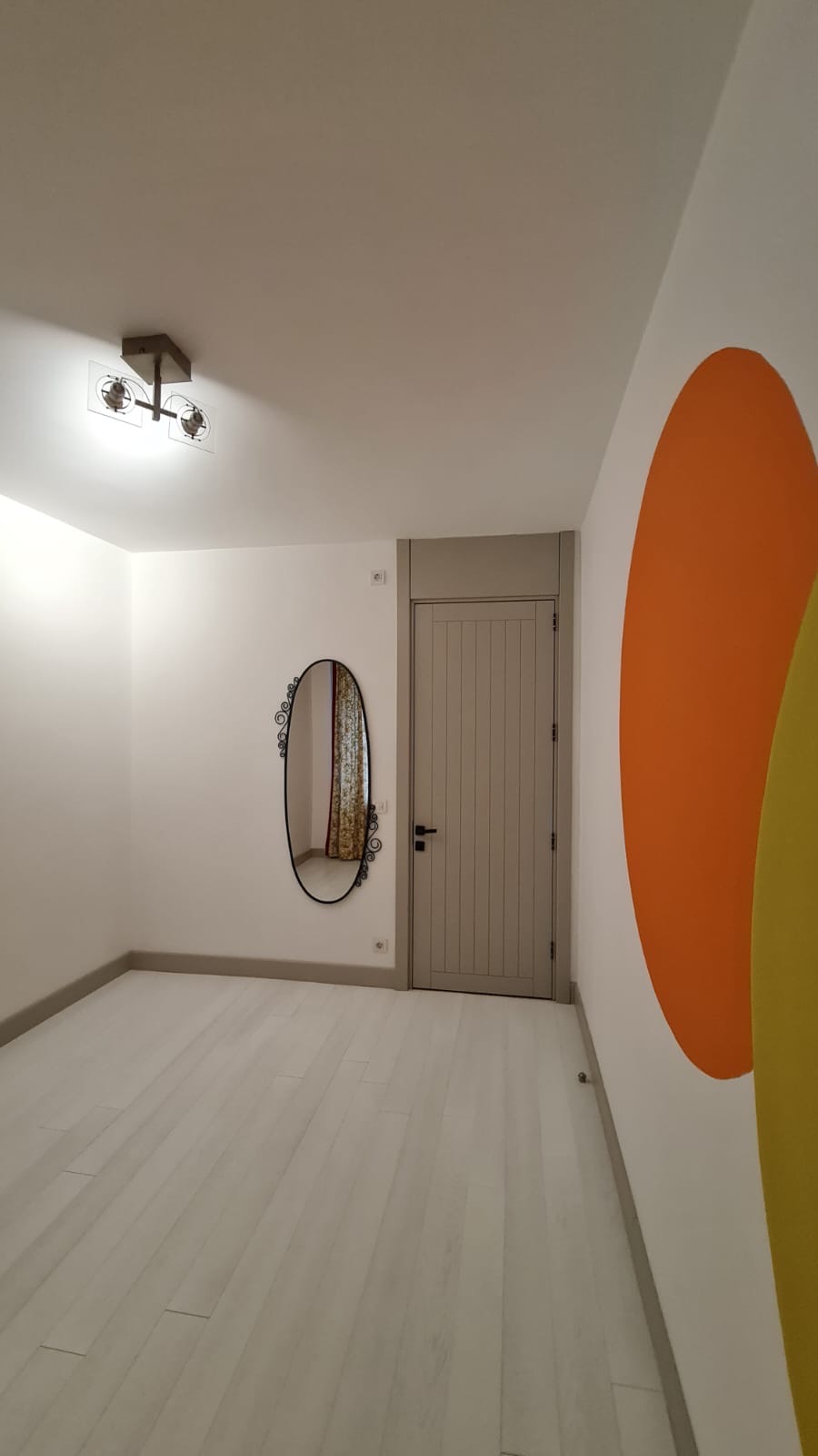 Vertical fluted lacquer door in warm stone with concealed frame detailing