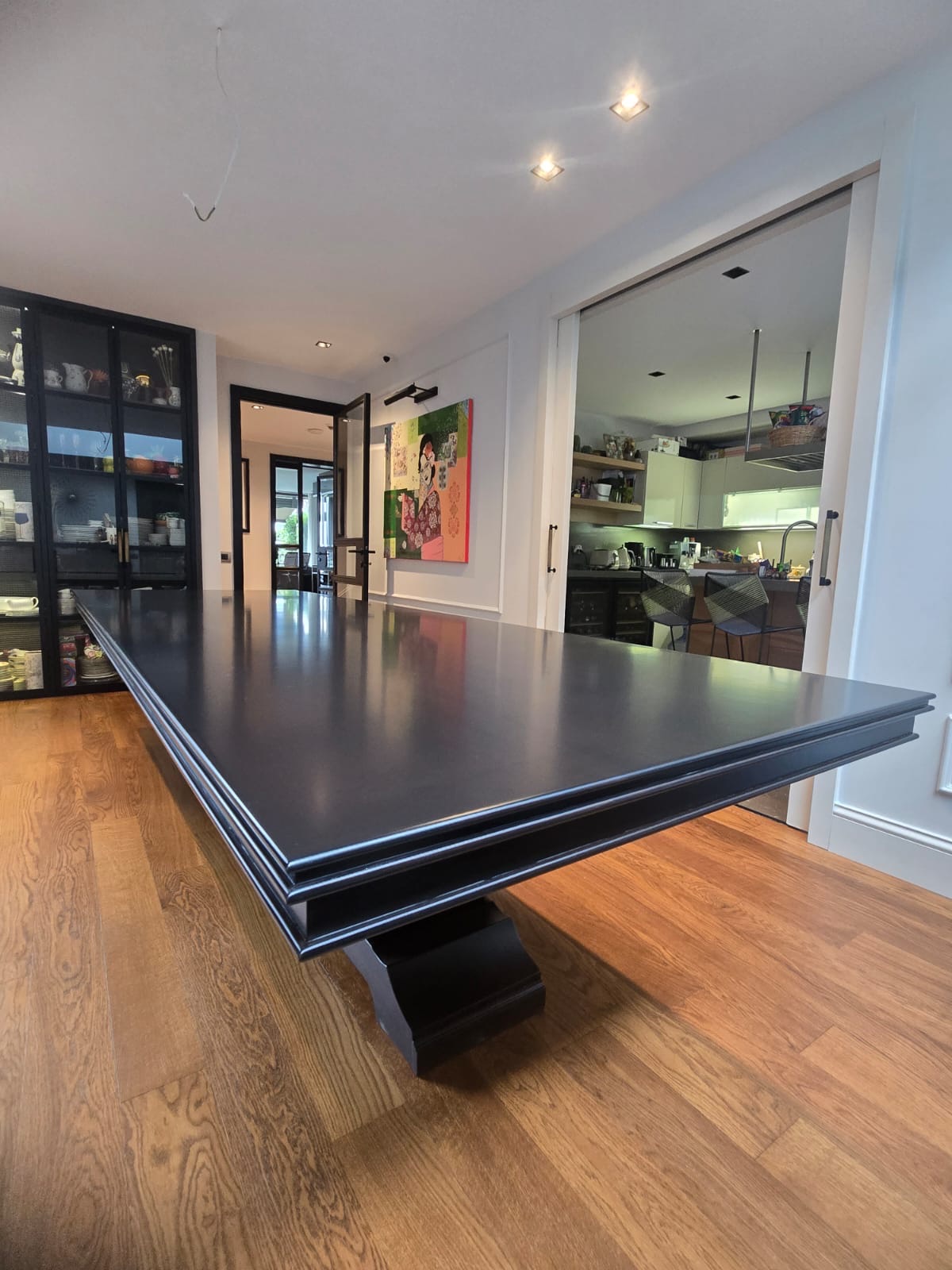 Long banquet table with layered moulded edge in satin black