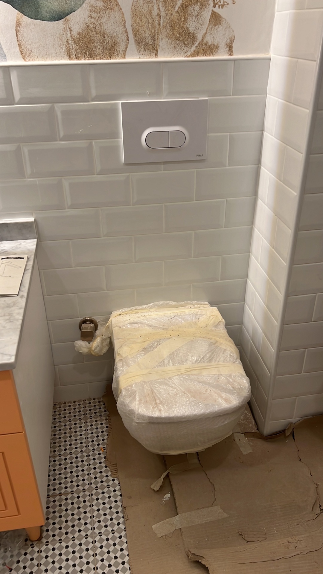 On-site installation detail — bevelled metro tiling and Carrara top