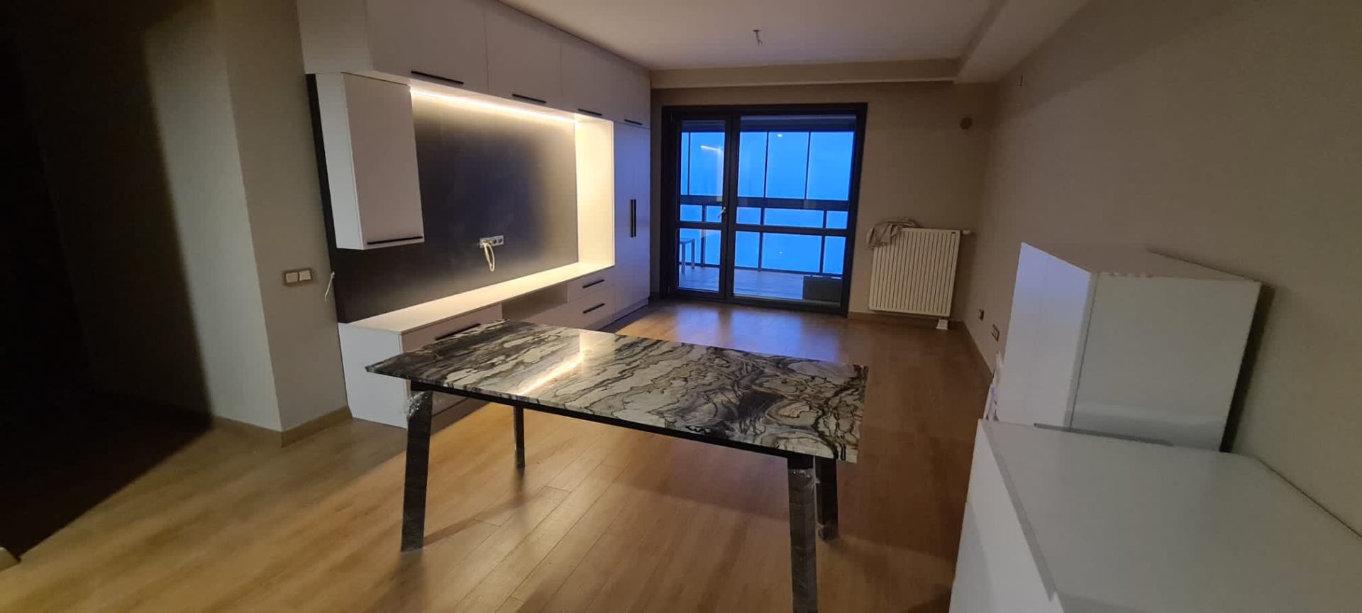 Book-matched marble dining table with polished steel legs